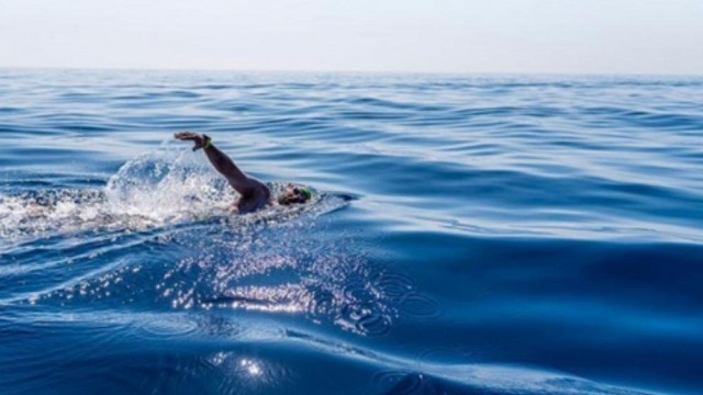After a near-death experience, this Olympian is breaking swimming records for the environment